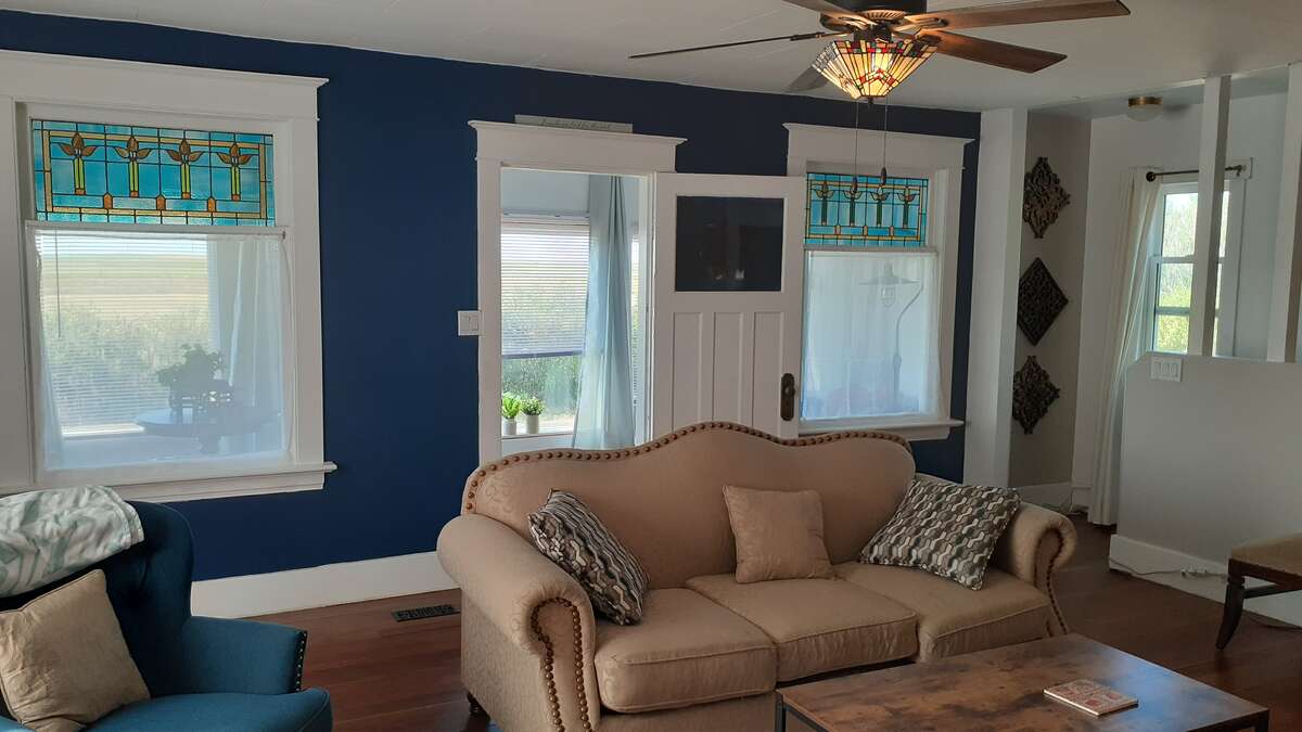 Living room. original stained glass leading to a 3 season porch