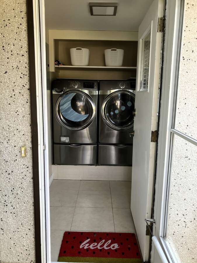 Back door entrance to mudroom with laundry facility