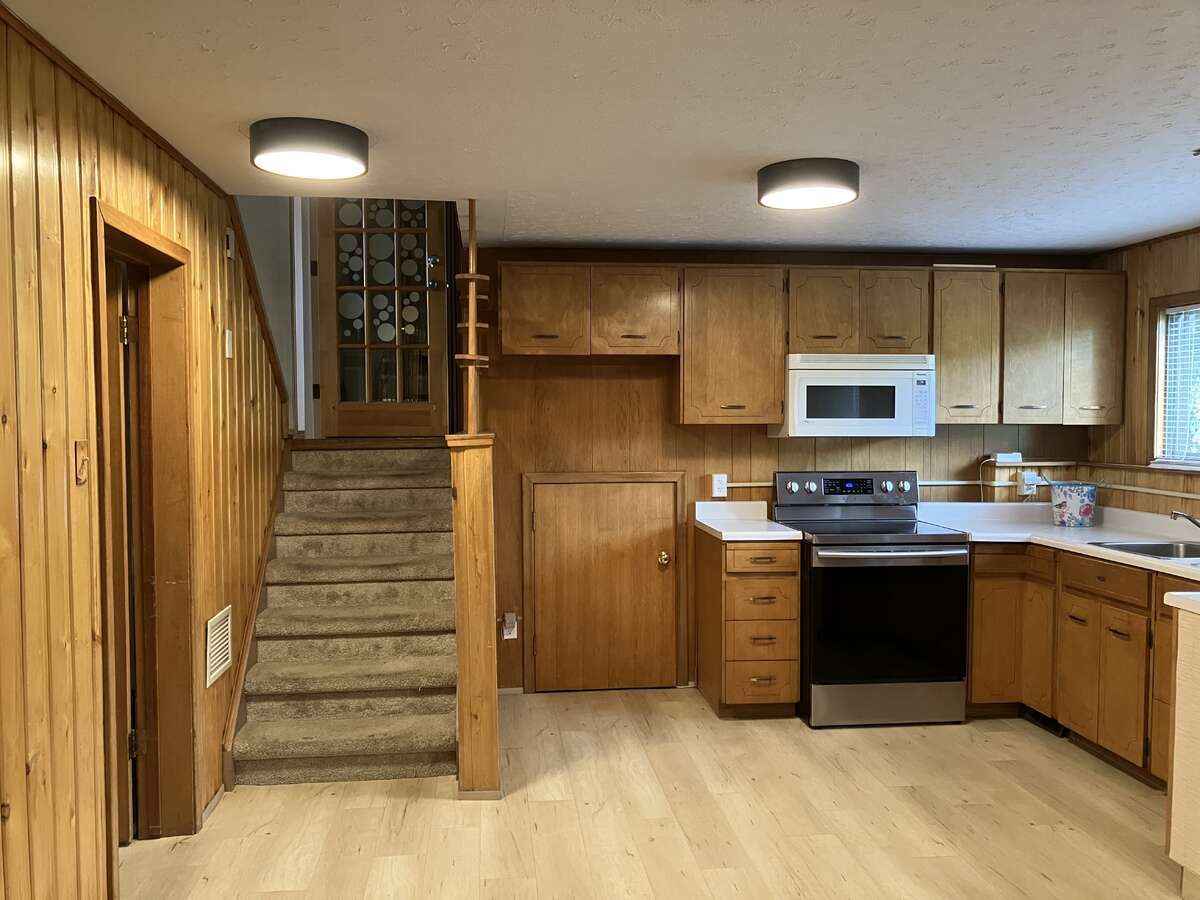Entrance to lower level with kitchenette and door to crawl/storage space