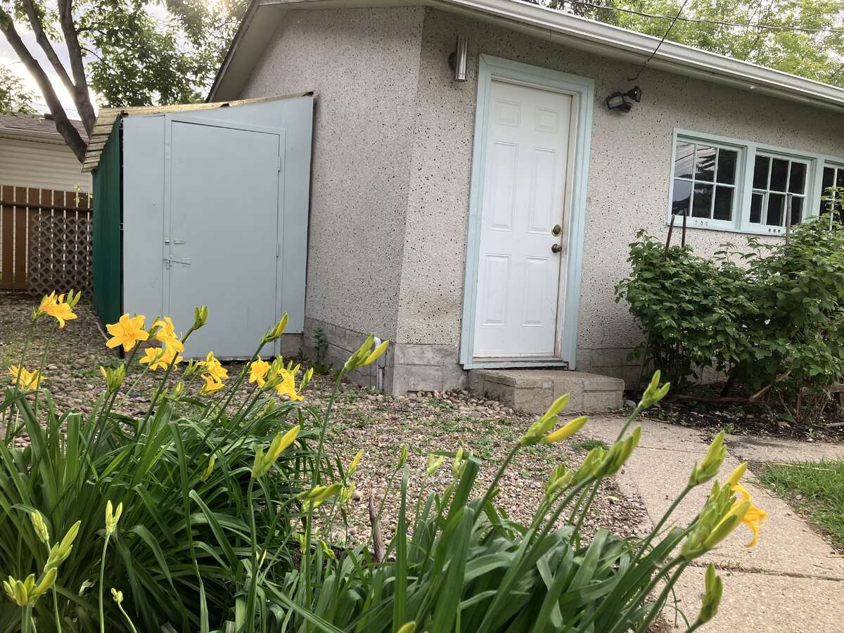 Garage with adjacent metal storage shed