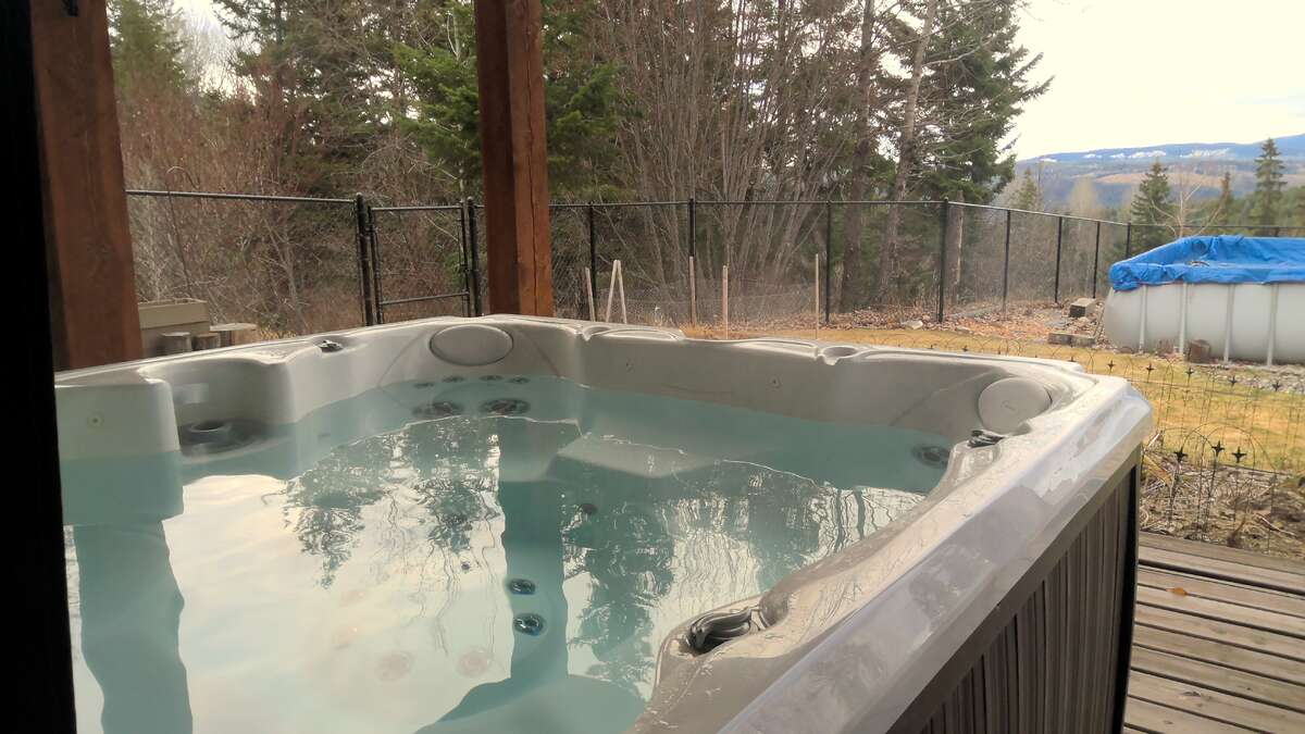 Covered hot tub on lower deck