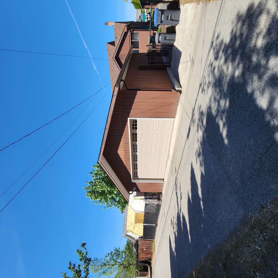 Detached garage beside cement pad with alley access