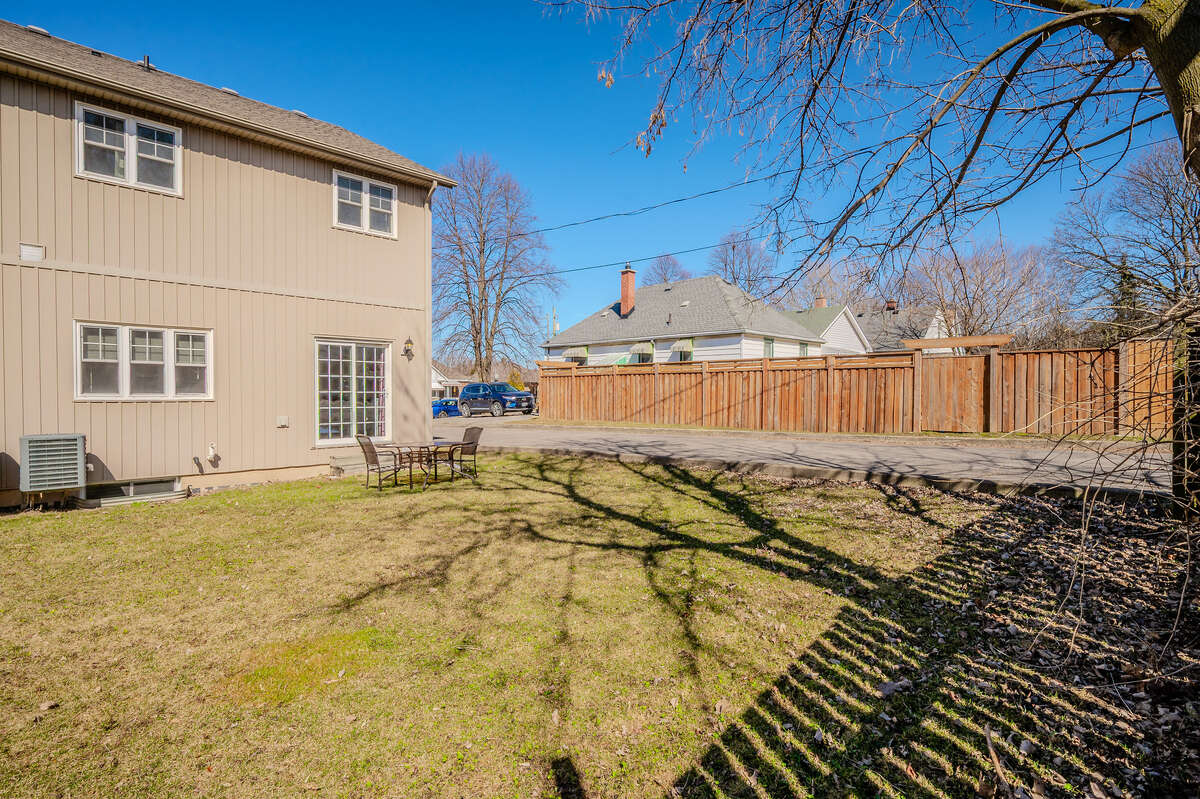 Spacious back yard is shaded in the summer by large neighbour's tree.
