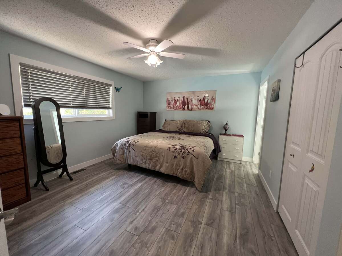 Large Master bedroom with walk in closet. Showing a King bed.