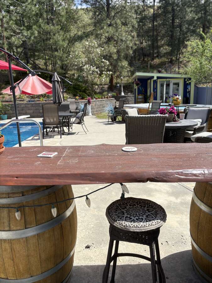 View from outdoor kitchen with running water and fridge