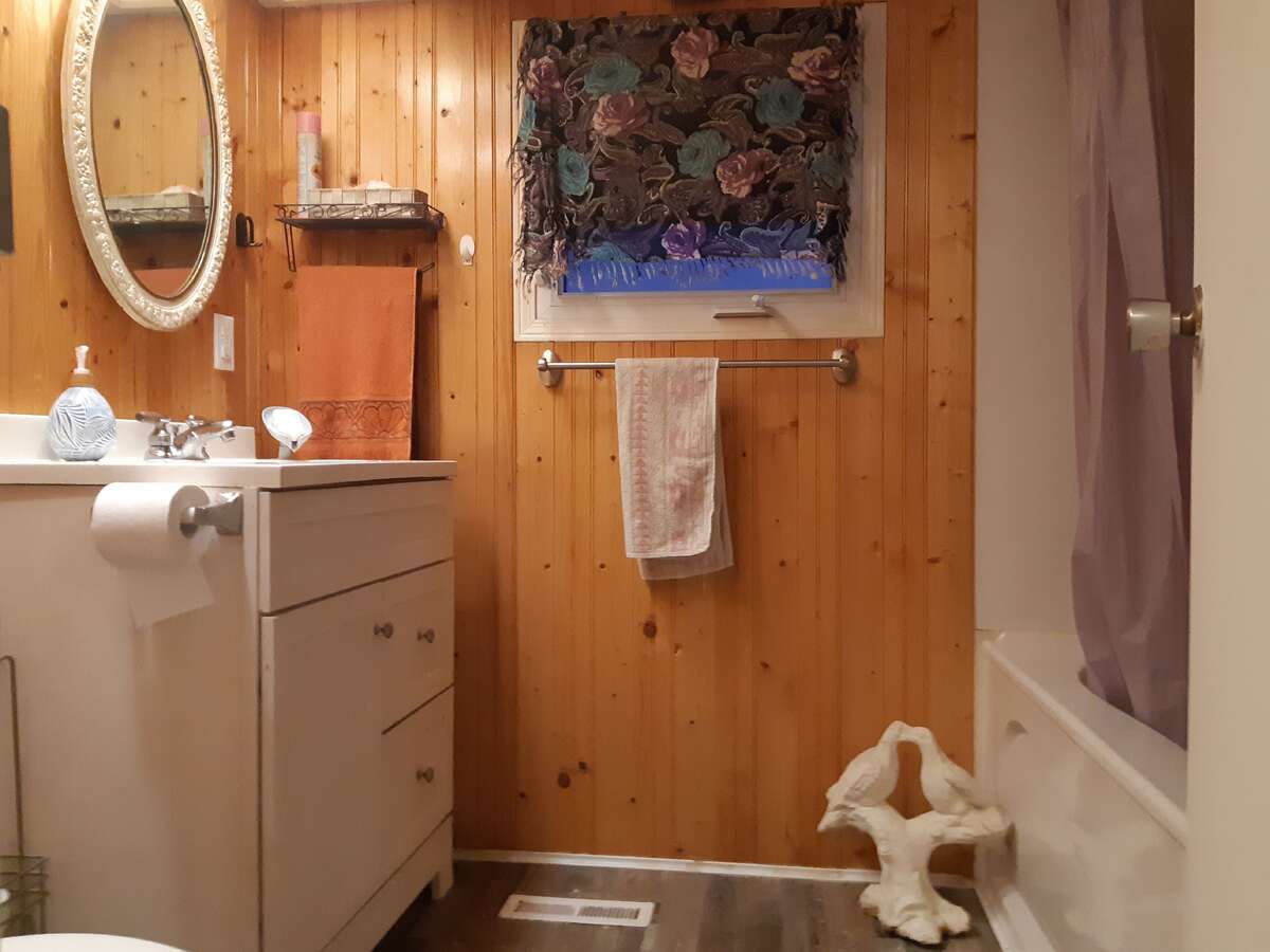 Laundry area with door to closet with shelves