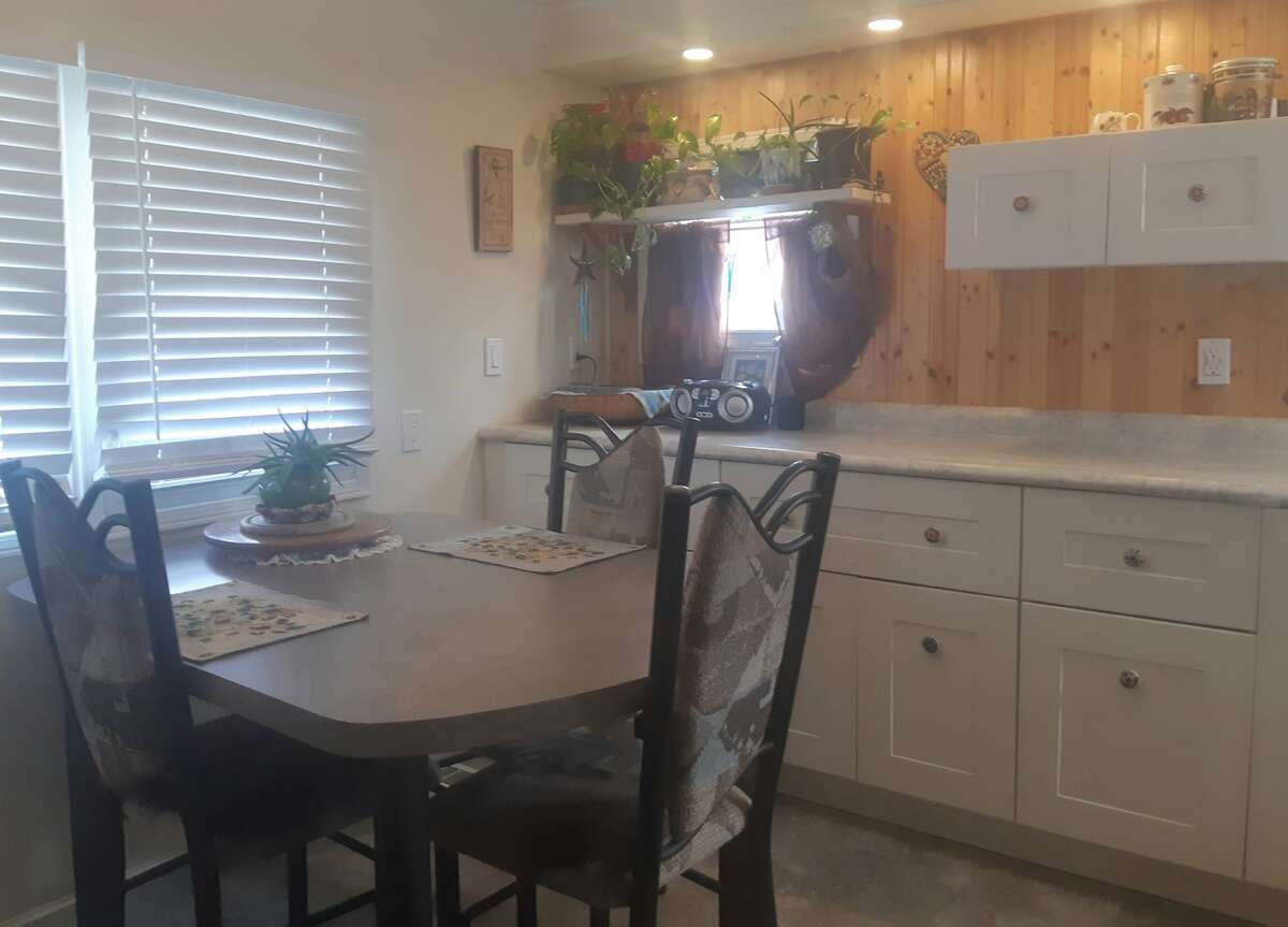 Window door is entry to garage and other door is shelved closet.