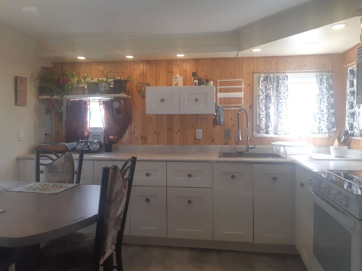 Window door is entry to garage and other door is shelved closet.