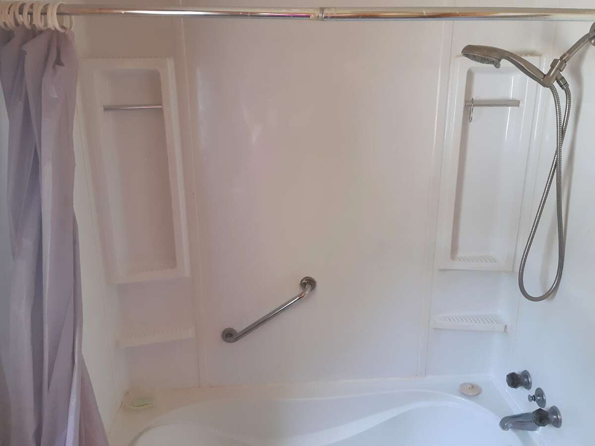 Laundry area with door to closet with shelves