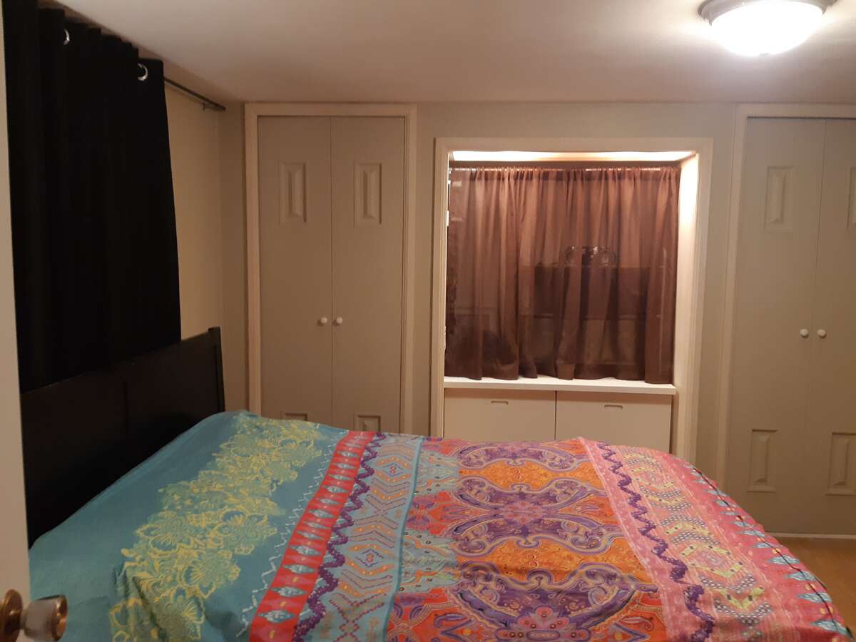 Laundry area with door to closet with shelves