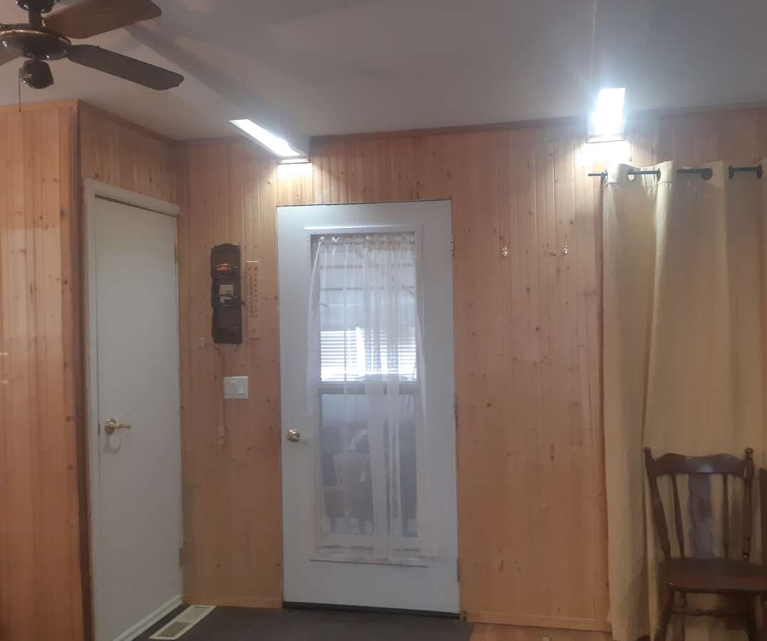 Window door is entry to garage and other door is shelved closet.