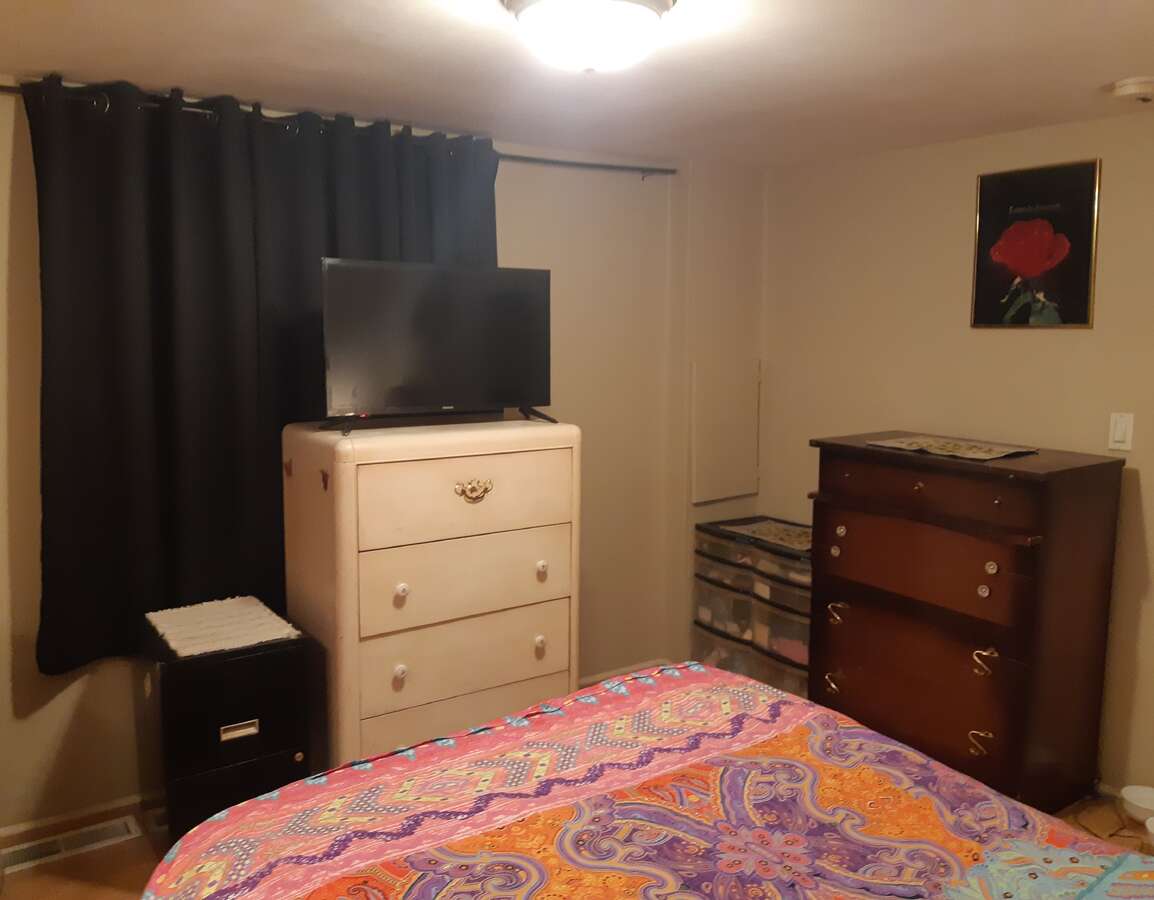 Laundry area with door to closet with shelves