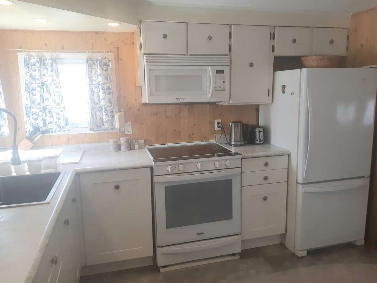 Window door is entry to garage and other door is shelved closet.