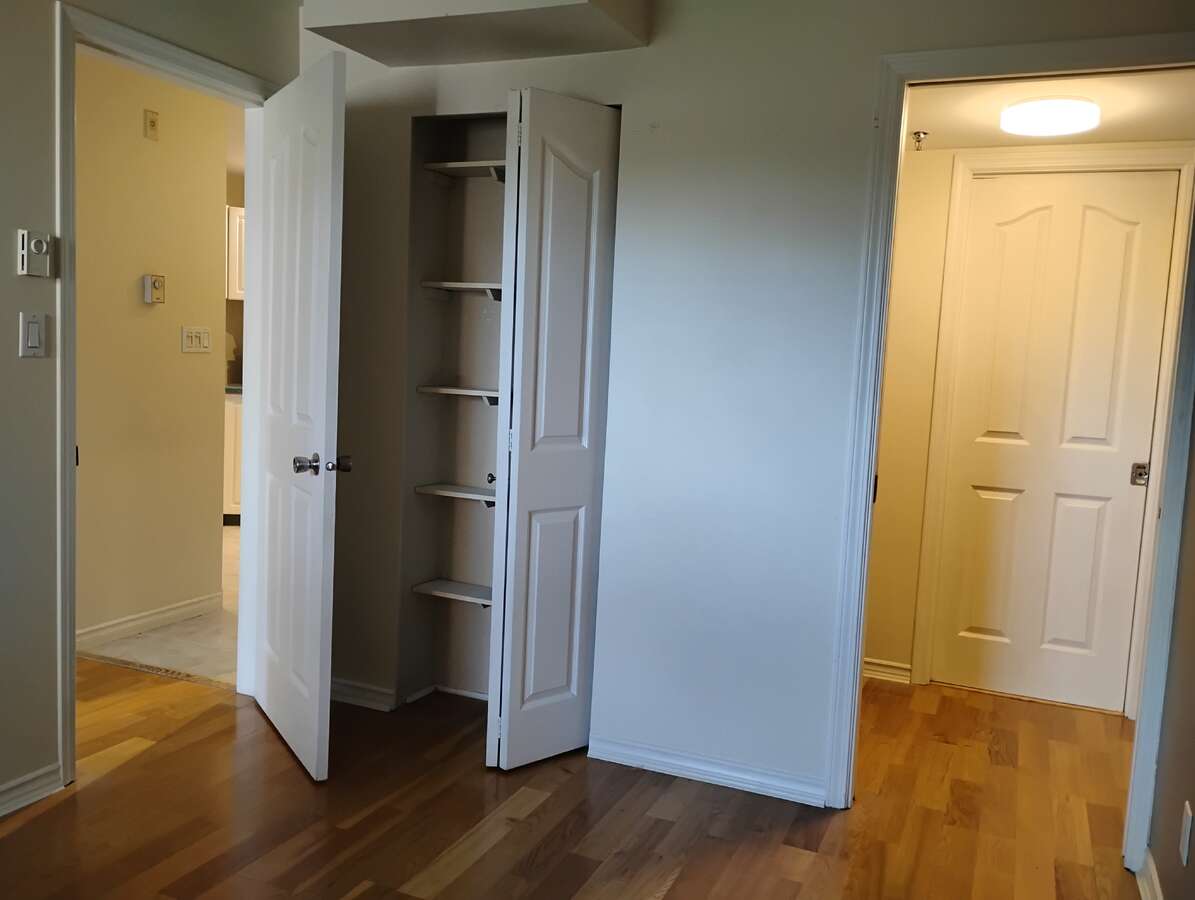 Bedroom 1 showing main door, small closet and walk in closet
