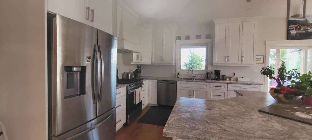 ice maker fridge, gas stove, dishwasher, and island with power