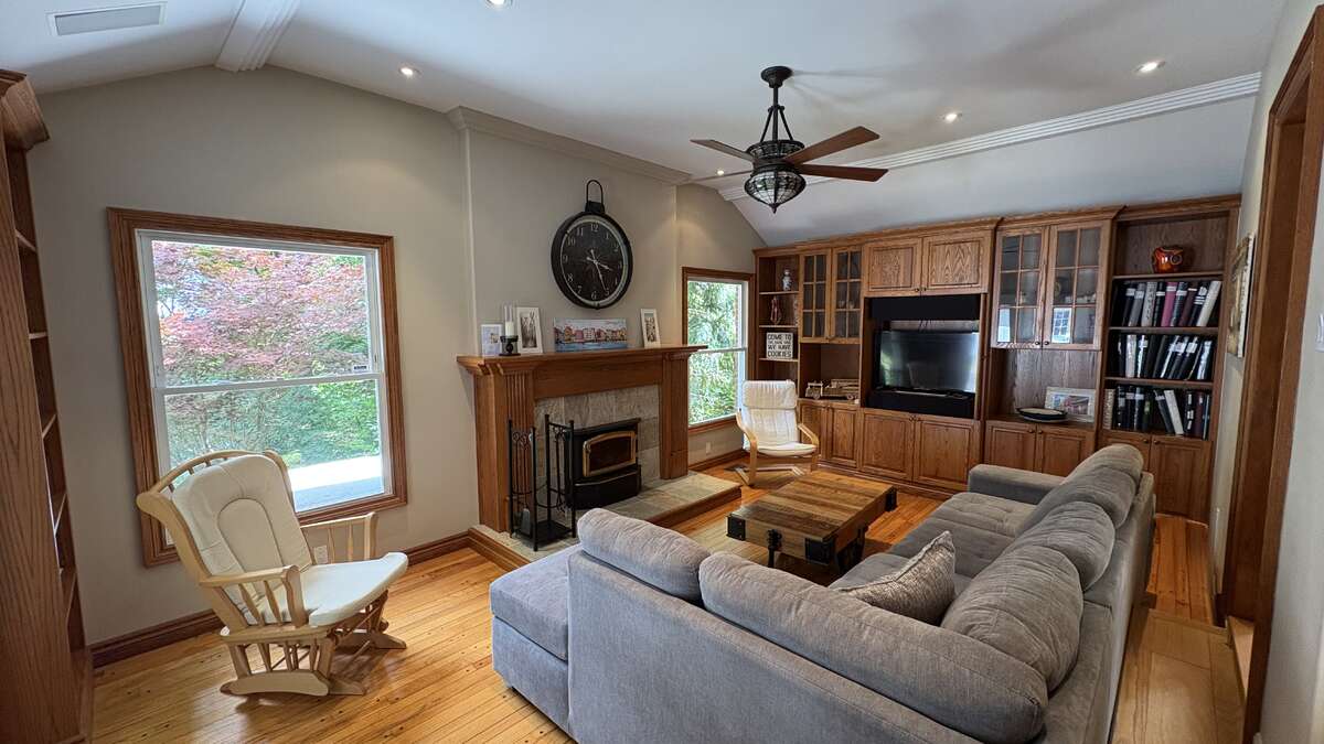 Den with woodburning fireplace