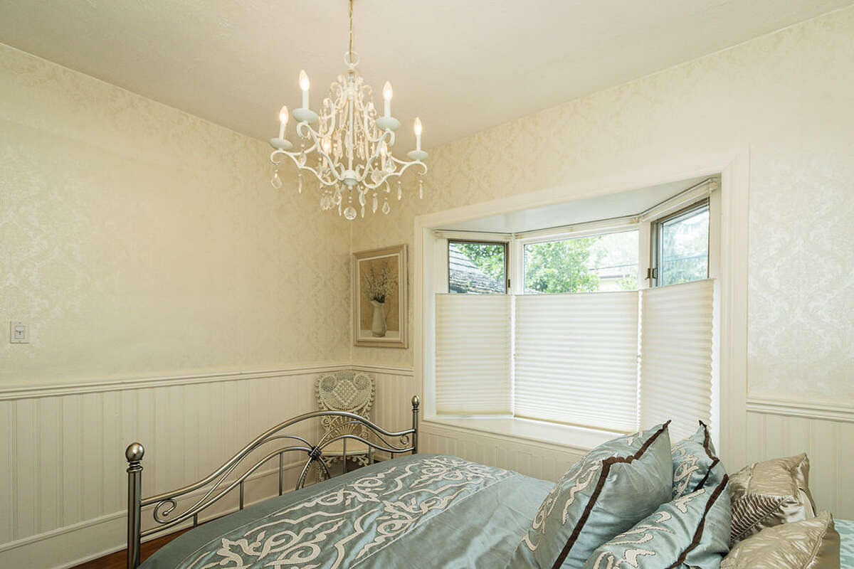 quiet and peaceful space, featuring a bay window overlooking the garden, classic wainscoting