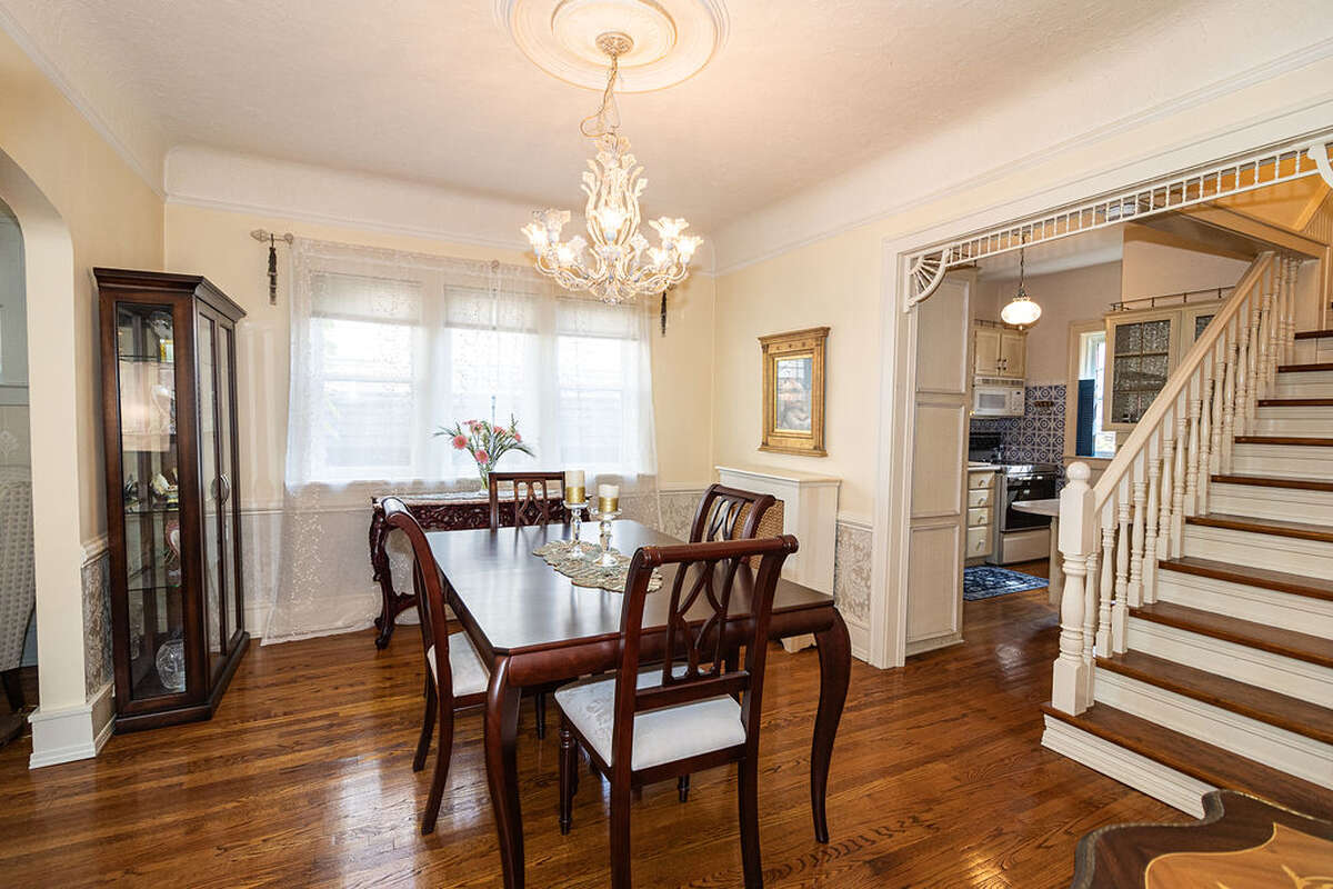 The dining room is spacious and bright, featuring elegant arched doorways.