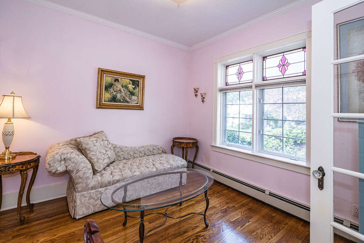 large windows with custom stained glass, and elegant Victorian tin ceiling panels