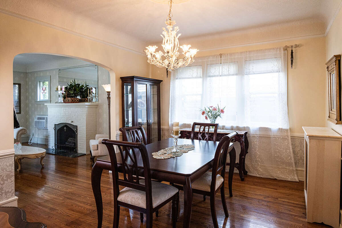 The dining room is spacious and bright, featuring elegant arched doorways.