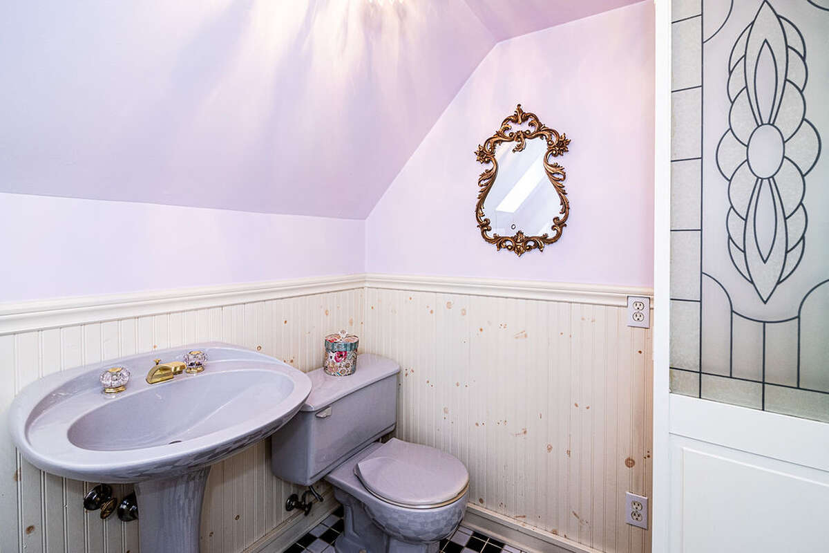 ensuite bathroom that includes a vintage clawfoot tub and iconic black-and-white checkered tiles
