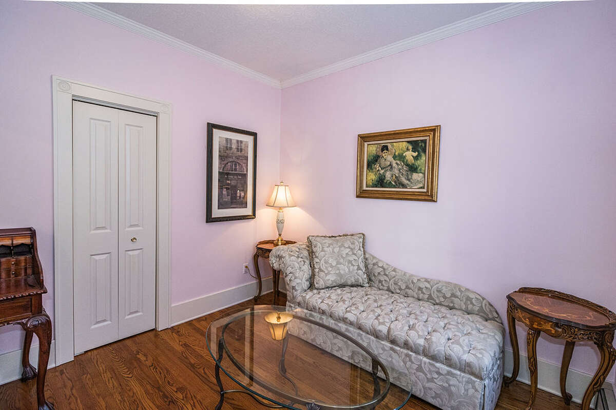 large windows with custom stained glass, and elegant Victorian tin ceiling panels