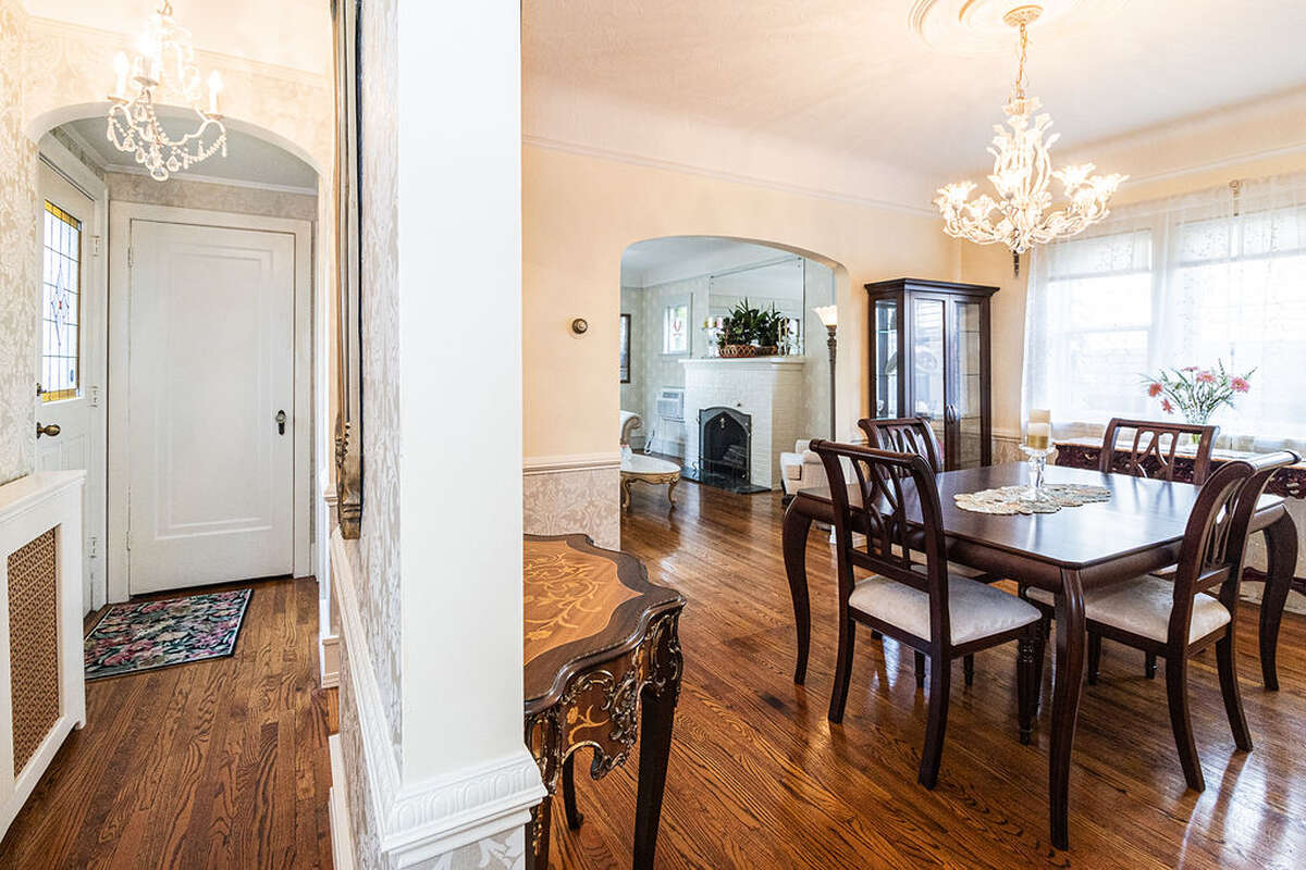 The dining room is spacious and bright, featuring elegant arched doorways.