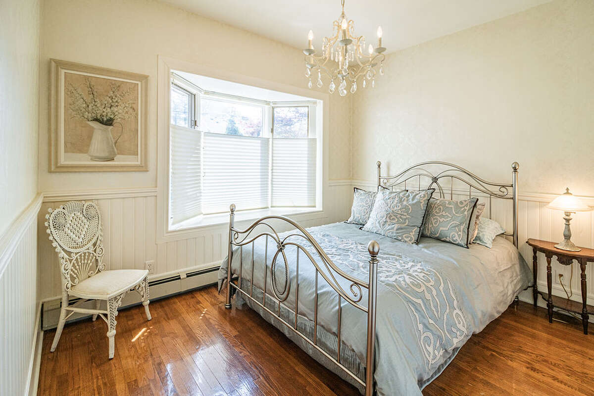 quiet and peaceful space, featuring a bay window overlooking the garden, classic wainscoting