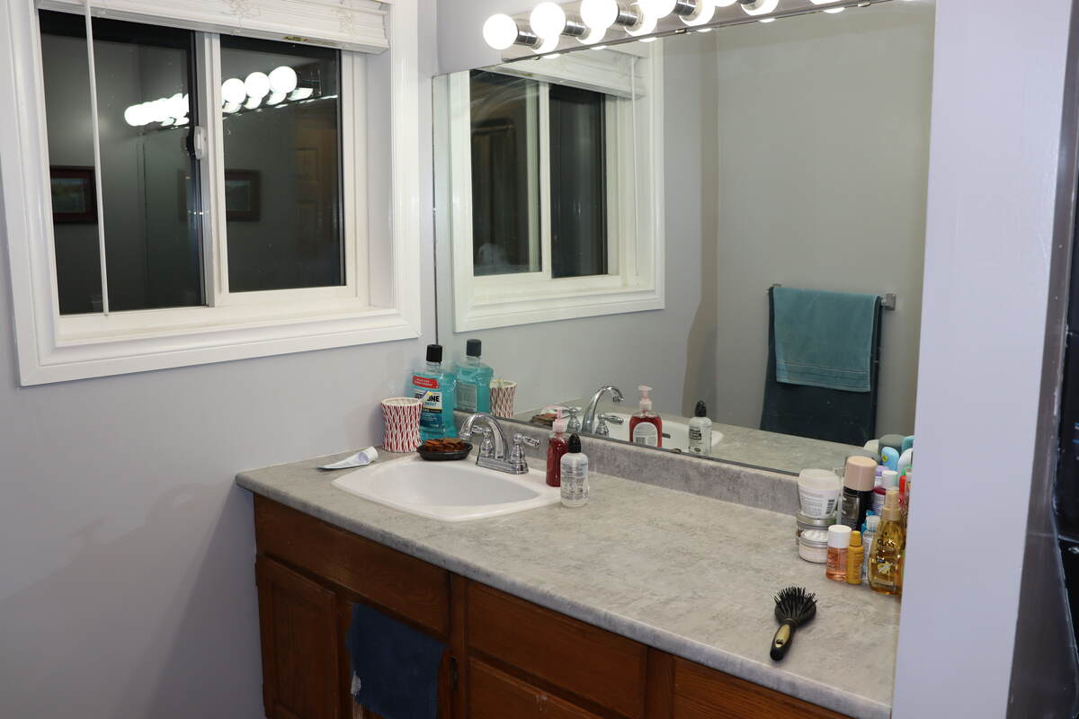 Bathroom vanity. All windows have custom blinds