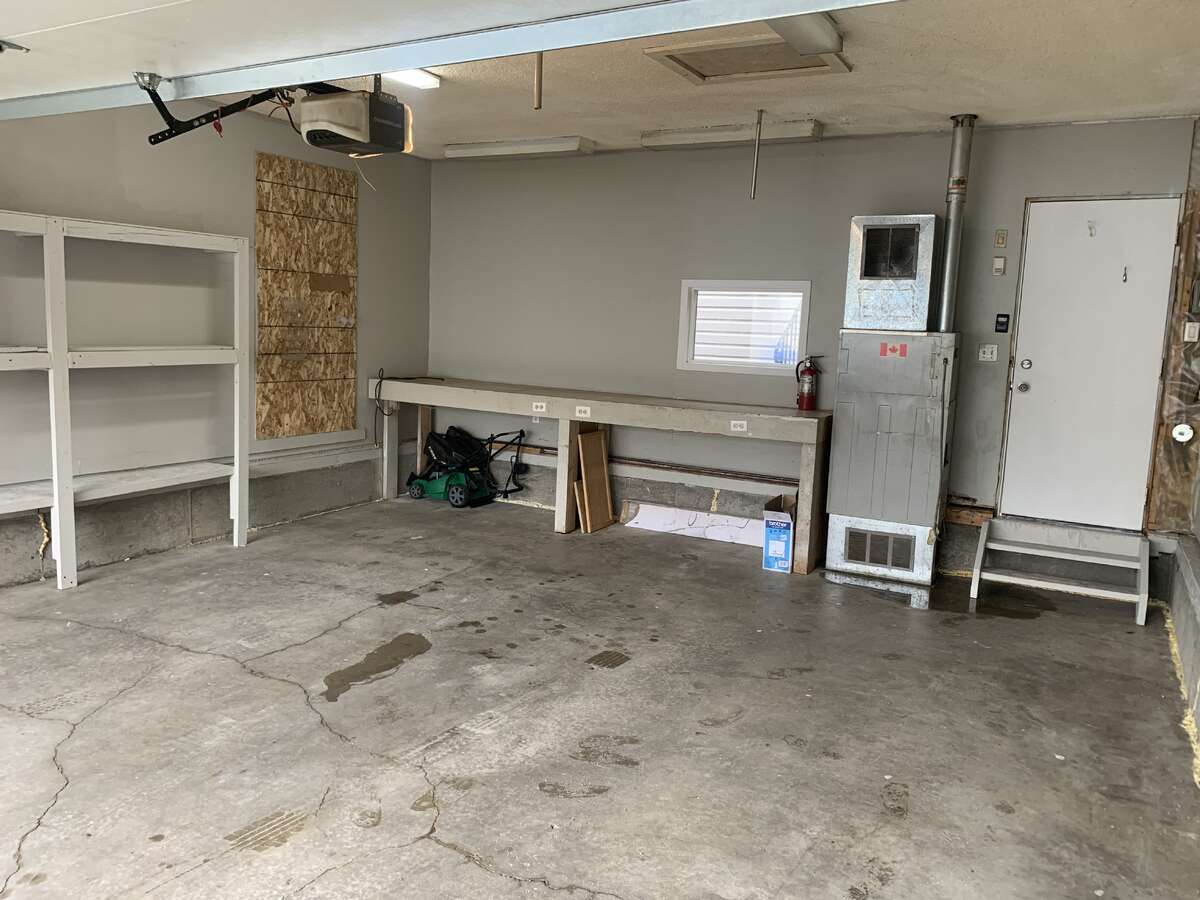 Garage with Worktable, Gas Furnace & Lawn Mower