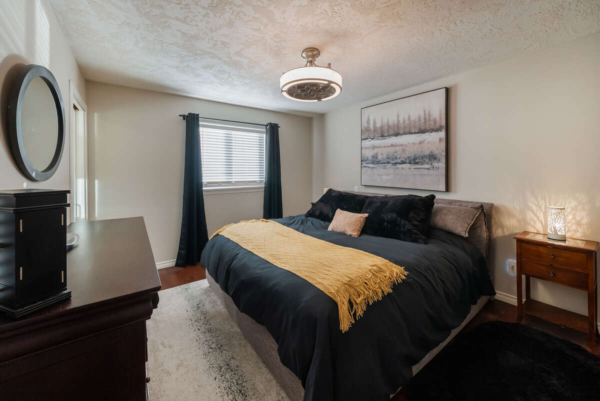 King size bed with modern ceiling fan
