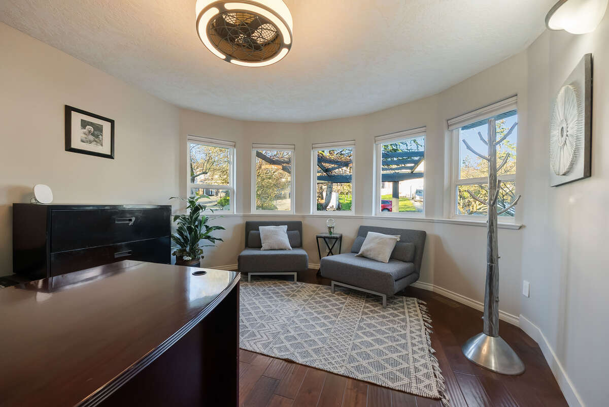 Den/Dining room with custom window coverings, views of grapevines and relaxing sounds of the pond.