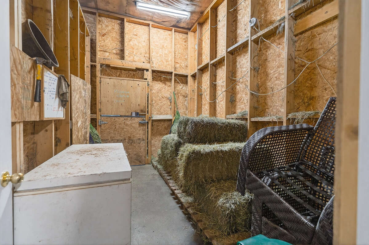 Dry hay and feed room with door entrance into stall area