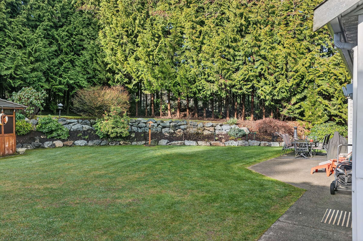 Very private & low maintenance perennial / rock gardens with 2nd pond.