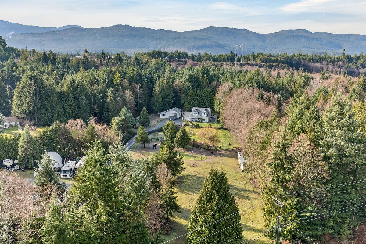 Ariel view from road looking at house with the beautiful Wesley Ridge as a back drop.