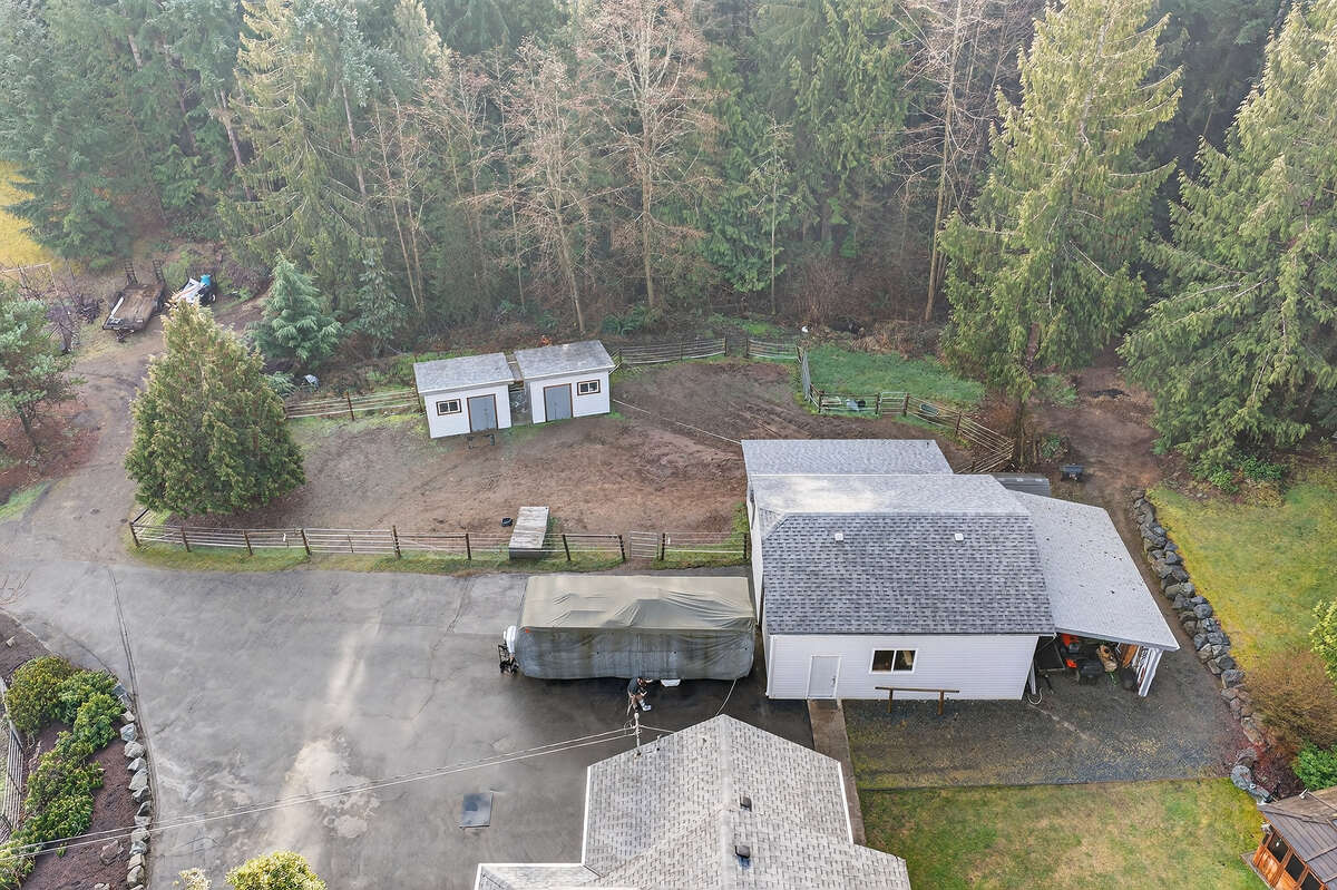 Upper paddock for horses, large shop with lean-to storage for equipment, lots of RV parking.