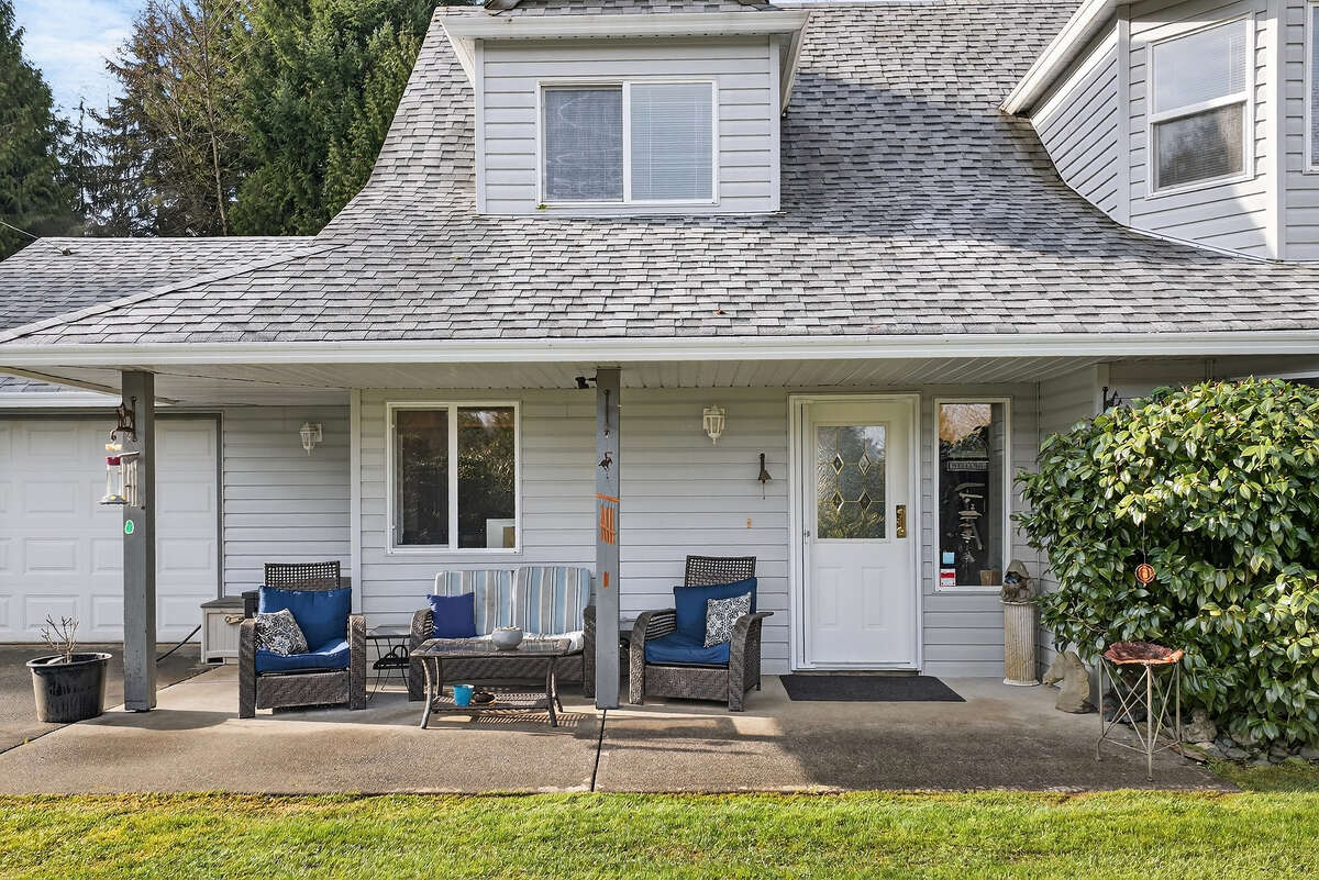 Covered sitting area to enjoy the beautiful property with gardes, pasture and pond.