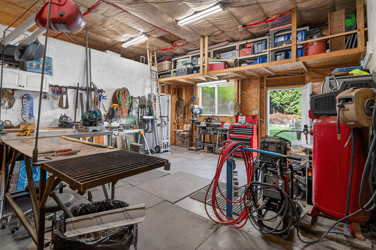 Shop with additional storage & access to attic & tack room.