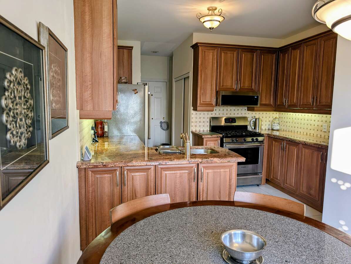 Long view of large kitchen prep area and in kitchen dining
