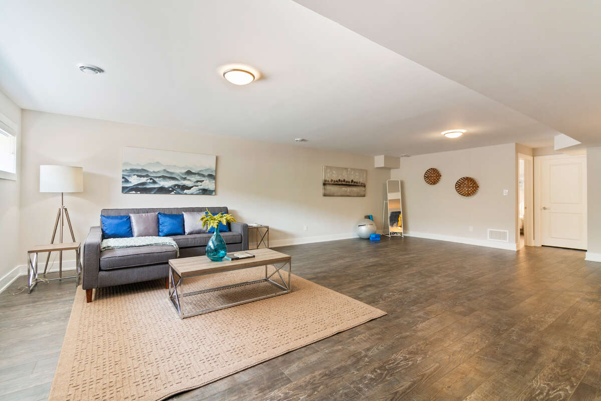 Large Basement - with couch and TV area, desk, and workout area.