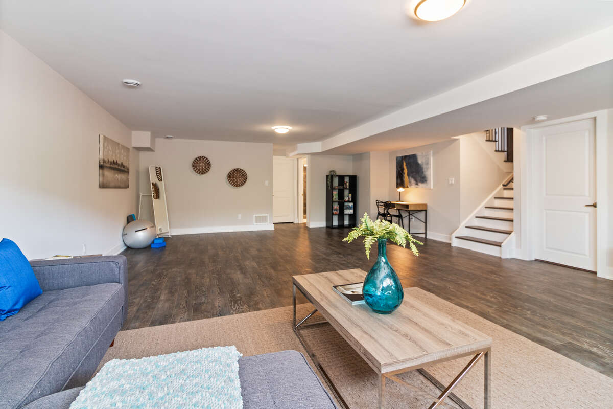 Large Basement - with couch and TV area, desk, and workout area.