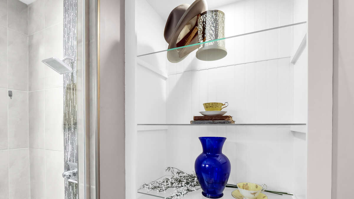Glass shelving adds to the spaciousness