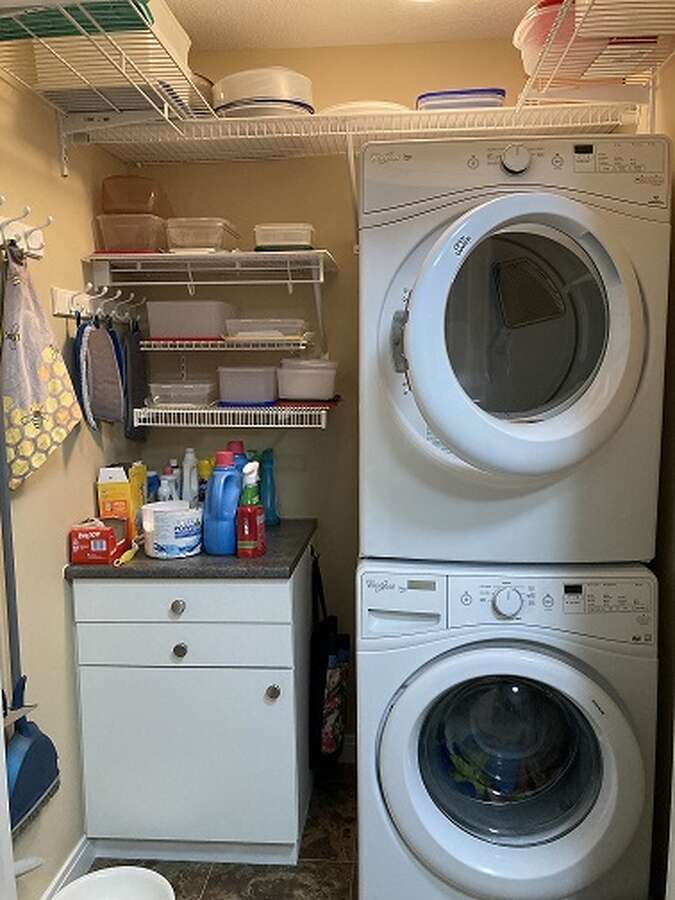 laundry room off den with new LG stacked  appliances