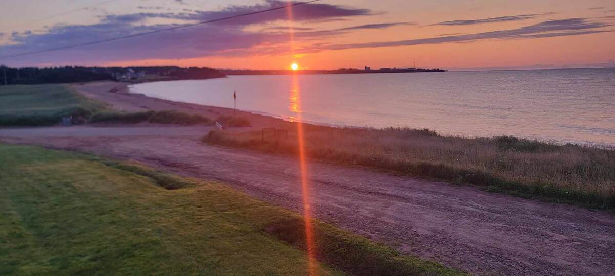 Sunrise from the side of the deck. Property on other side of right of way is part of property - up to high tide line on the beach