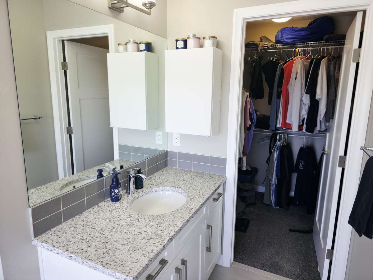 UPPER LEVEL - PRIMARY BATHROOM - HIS SIDE - SINK AND WALK-IN CLOSET
