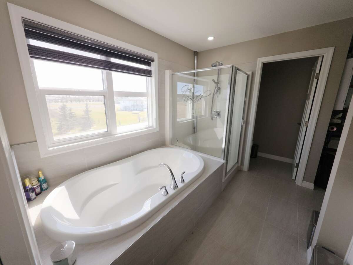 UPPER LEVEL - PRIMARY BATHROOM - LUXURIOUS BATH TUB & WALK-IN SHOWER