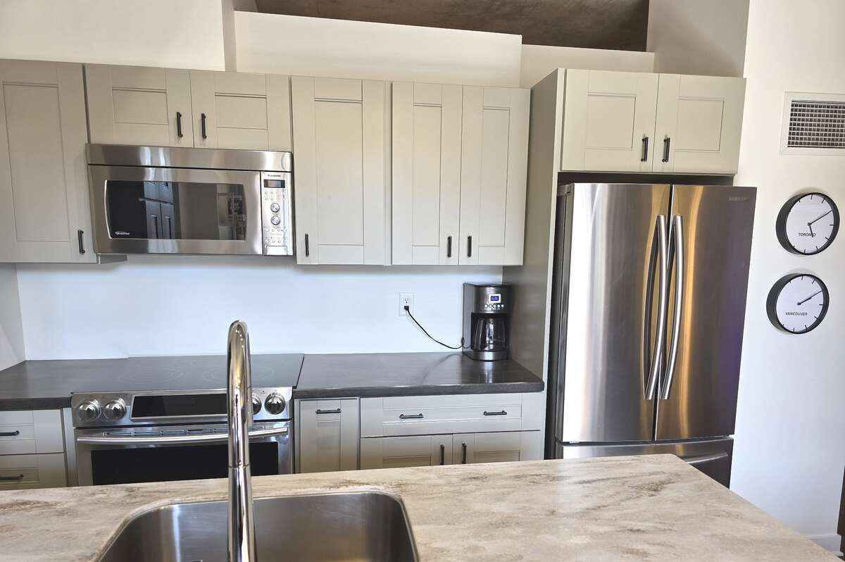 Modern kitchen with stainless steel appliances and ample storage.