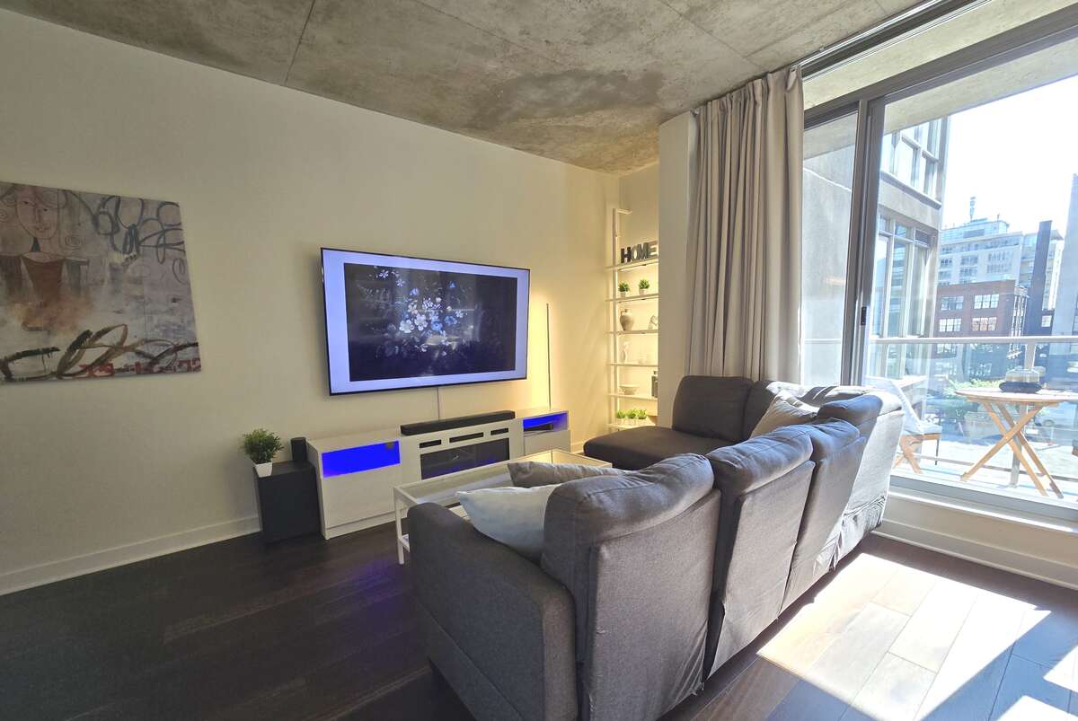 Modern living area with large windows and access to a private balcony, perfect for enjoying city views.