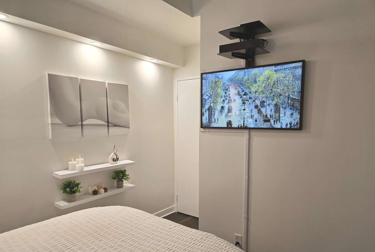 Stylish bedroom with customizable coloured accent lighting.