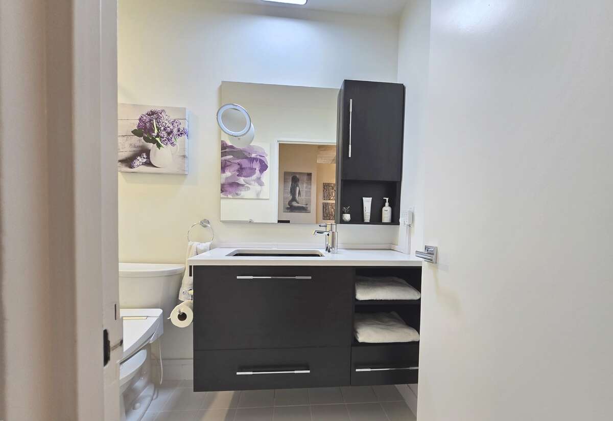 Bright and clean bathroom with modern fixtures and ample storage.